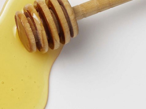 honey with wooden honey dipper